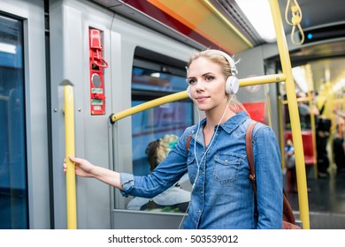 Beautiful Young Woman With Headphones In Subway Train