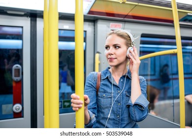 Beautiful Young Woman With Headphones In Subway Train