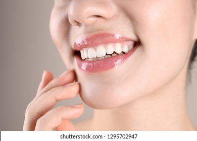 Beautiful young woman with healthy teeth on color background, closeup - Shutterstock ID 1295702947