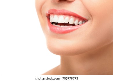 Beautiful young woman with healthy teeth on white background