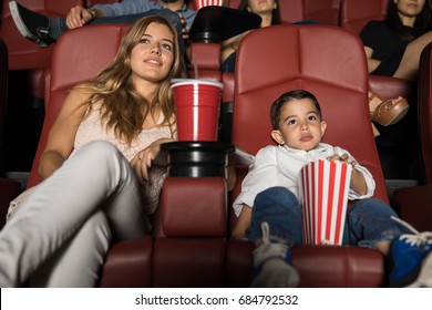 Beautiful Young Woman And Her Son Watching A Movie In A Cinema Theater During A Date Night