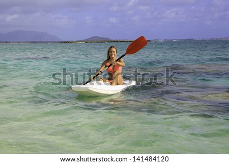beautiful young woman with her surf ski