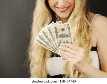 Beautiful young woman holding 500 dollars 