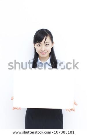 beautiful young woman holding blank billboard