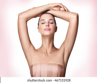 Beautiful Young Woman Holding Her Arms Up And Showing Clean Underarms. Armpit's Care. Armpit Epilation, Hair Removal, Perfect Skin.