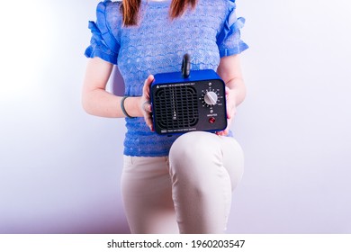 Beautiful Young Woman Holding An Ozone Generating Machine. Disinfection Concept On White Background. Covid 19. Industrial Equipment