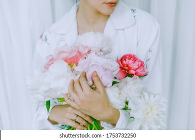 Beautiful Young Woman Holding Pink And White Peony Bouquet. Modern Floral Aesthetic, Green Trendy Tone. Stylish Girl In White Floral Shirt Holding Peonies Flowers In Hands With Jewelry