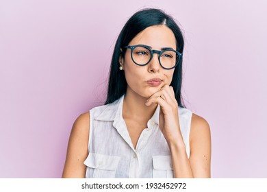 Beautiful Young Woman Holding Pink Cancer Ribbon Looking Away To Side With Smile On Face, Natural Expression. Laughing Confident. 