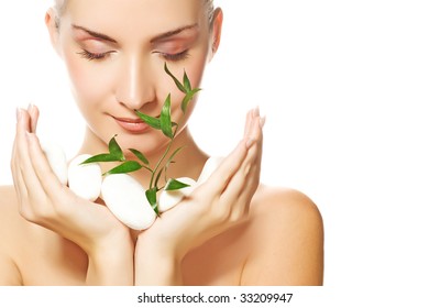 Beautiful Young Woman Holding Plant Growing Up Through Stones