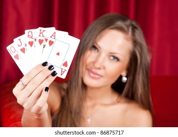 Beautiful Young Woman Holding Poker Cards