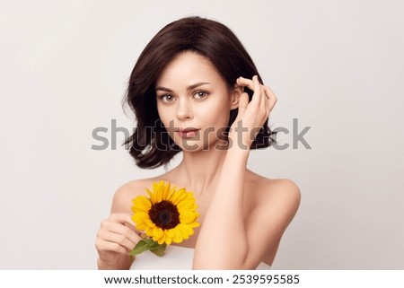 Woman holding sunflowers