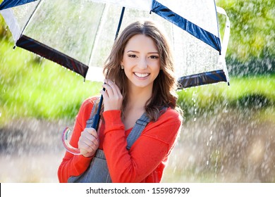 Beautiful Young Woman Holding  Umbrella Out In The Rain