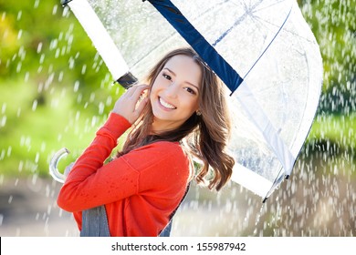 Beautiful Young Woman Holding  Umbrella Out In The Rain