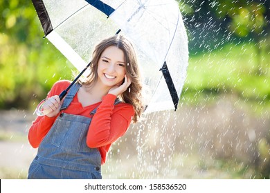 Beautiful Young Woman Holding Umbrella Out In The Rain