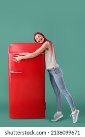 Beautiful Young Woman Hugging Red Fridge On Green Background