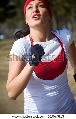Beautiful young  woman jogging cross country