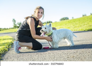 A Beautiful Young Woman Jogging With Her Dog