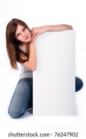 Beautiful Young Woman Kneeling Behind Sign