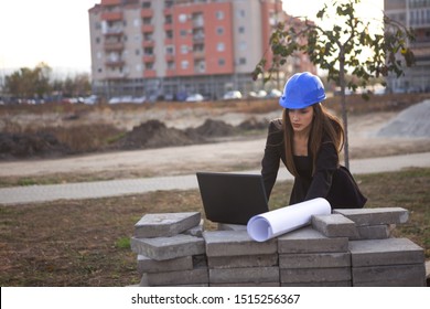 A Beautiful Young Woman Landscape Architect Is Looking At A Construction Project On A Computer While She Is At A Construction Site.