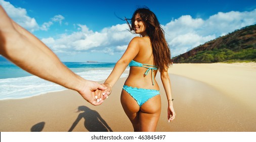 Beautiful Young Woman Leading Man Down The Beach, POV Perspective View