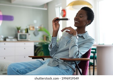 A Beautiful Young Woman Is Learning To Play The Mouth Organ Harmonica. 