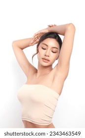 Beautiful Young woman lifting hands up to show off clean and hygienic armpits or underarms on white background, Smooth armpit cleanliness and protection concept