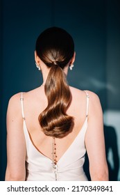 Beautiful Young Woman with Long Healthy and Shiny Smooth Hair. Bride with Hairstyle Low Ponytail, Back View