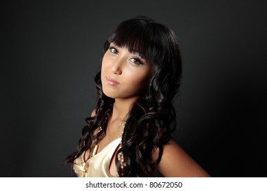 Beautiful Young Woman With Long Luscious Shiny Dark Hair Lightly Curled.