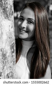 Beautiful Young Woman Looking At Cell Phone In Public Square