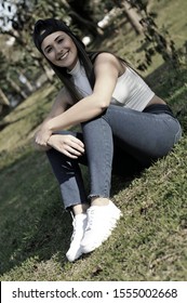 Beautiful Young Woman Looking At Cell Phone In Public Square