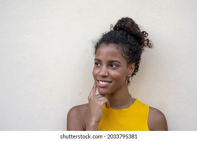 Beautiful Young Woman Looking Up And Smiling, African Girl Thinking About An Idea, Natural Skin And Genuine Portrait