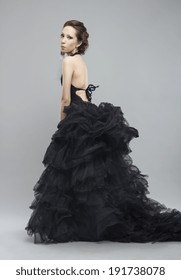 Beautiful young woman in luxurious long black dress.Fashion photo.