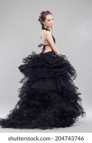 Beautiful young woman in luxurious long black dress.Fashion photo.