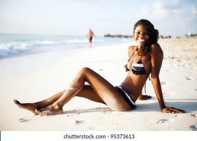 Beautiful young woman lying at the beach