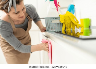 Beautiful young woman makes cleaning the house. Girl rubs dust - Shutterstock ID 2289536043