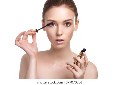 Beautiful Young Woman With Makeup Brush Applying Black Mascara On Eyelashes Isolated On White Background. Skin Care Theme