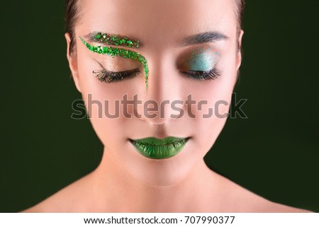 beautiful young woman with make-up in green tones