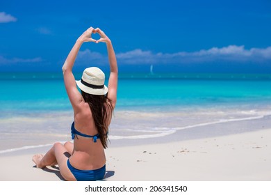 Beautiful Young Woman Making A Heart With Hands On Beach