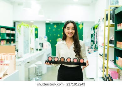 Beautiful young woman making a product demonstration while working as a salesperson at the make up shop - Shutterstock ID 2171812243