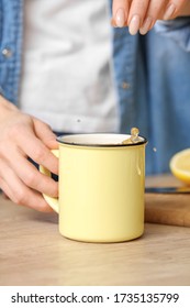 Beautiful Young Woman Making Tea With Lemon At Home, Closeup