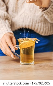 Beautiful Young Woman Making Tea With Lemon At Home, Closeup