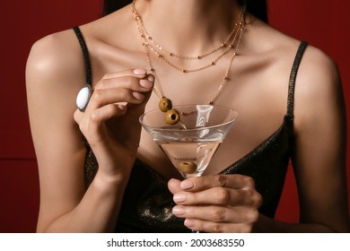 Beautiful young woman with martini on dark background, closeup - Powered by Shutterstock
