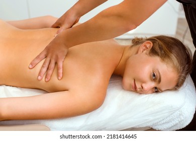 A beautiful young woman in the massage therapist's office lies on the couch. - Shutterstock ID 2181414645