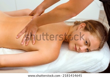 A beautiful young woman in the massage therapist's office lies on the couch.