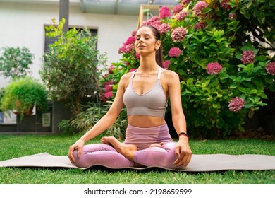 Beautiful young woman meditating in her garden, deep breaths  - Powered by Shutterstock