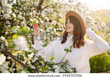 Beautiful young woman near blooming spring tree. Youth, love, fashion, romantic and lifestyle concept.