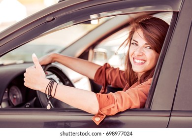 Beautiful young woman in the nice car is going to vacation. - Shutterstock ID 698977024
