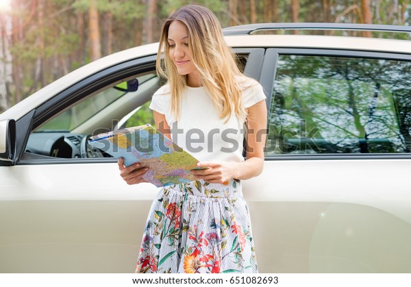 beautiful young woman in the nice car is going to\
vacation to the beach