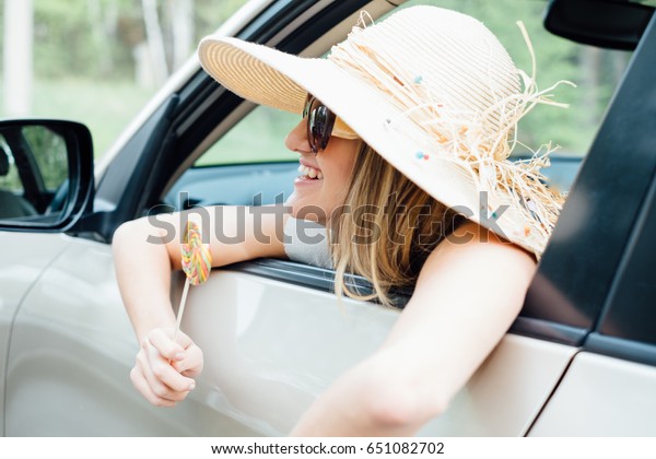 beautiful young woman in the nice car is going to\
vacation to the beach