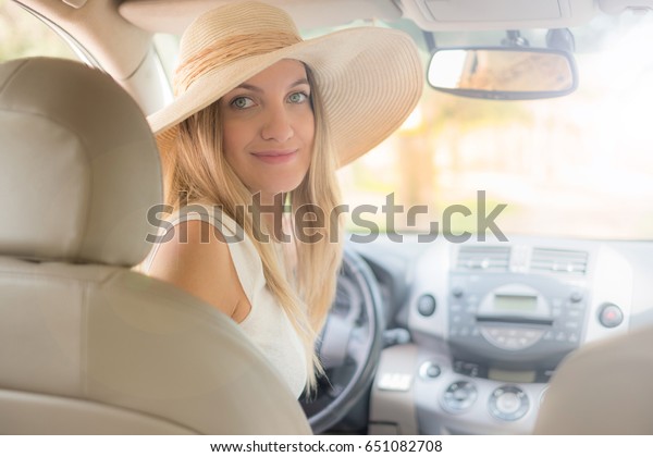 beautiful young woman in the nice car is going to
vacation to the beach